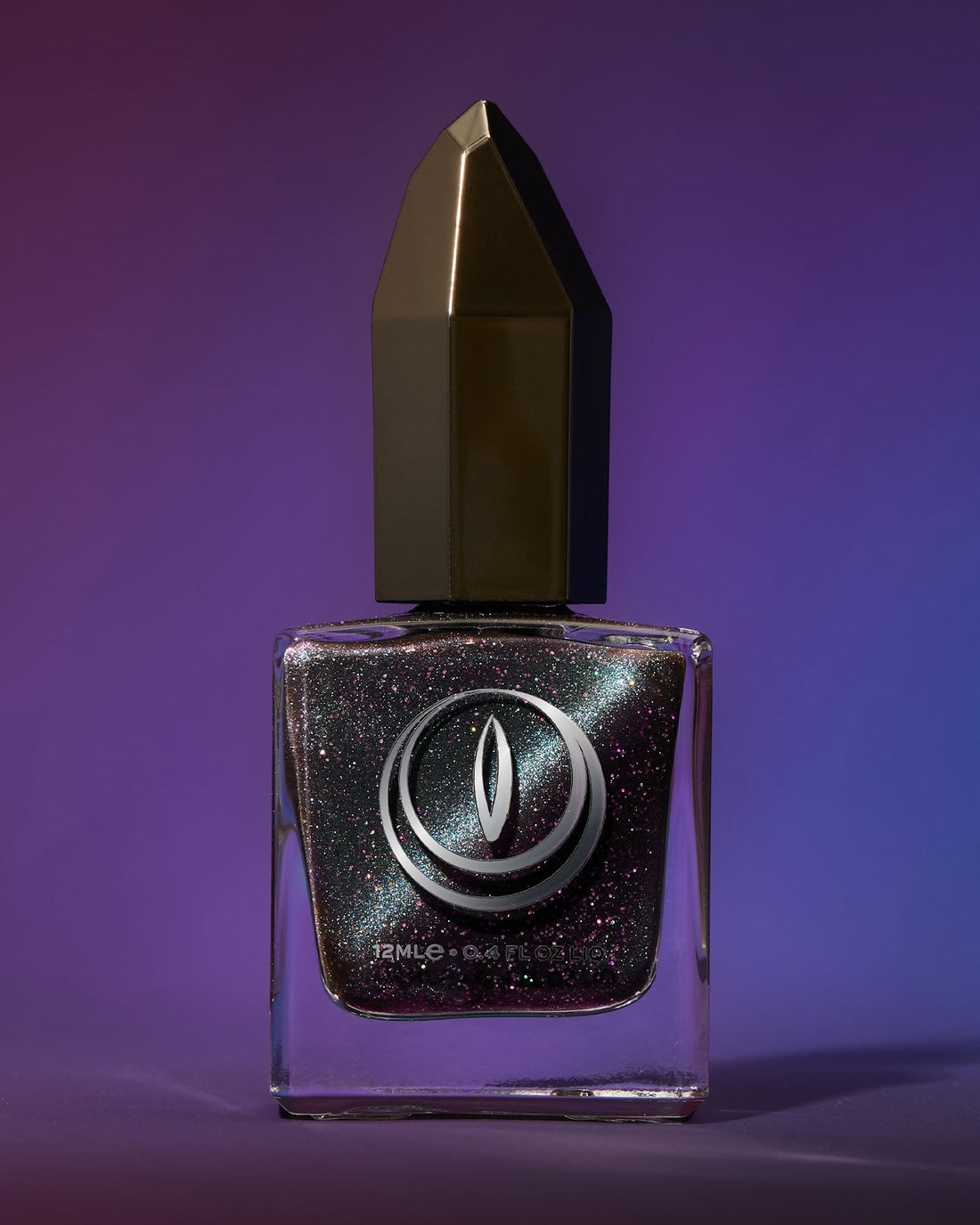 Sleek square glass bottle of dark metallic magnetic glitter nail polish with faceted gold black cap