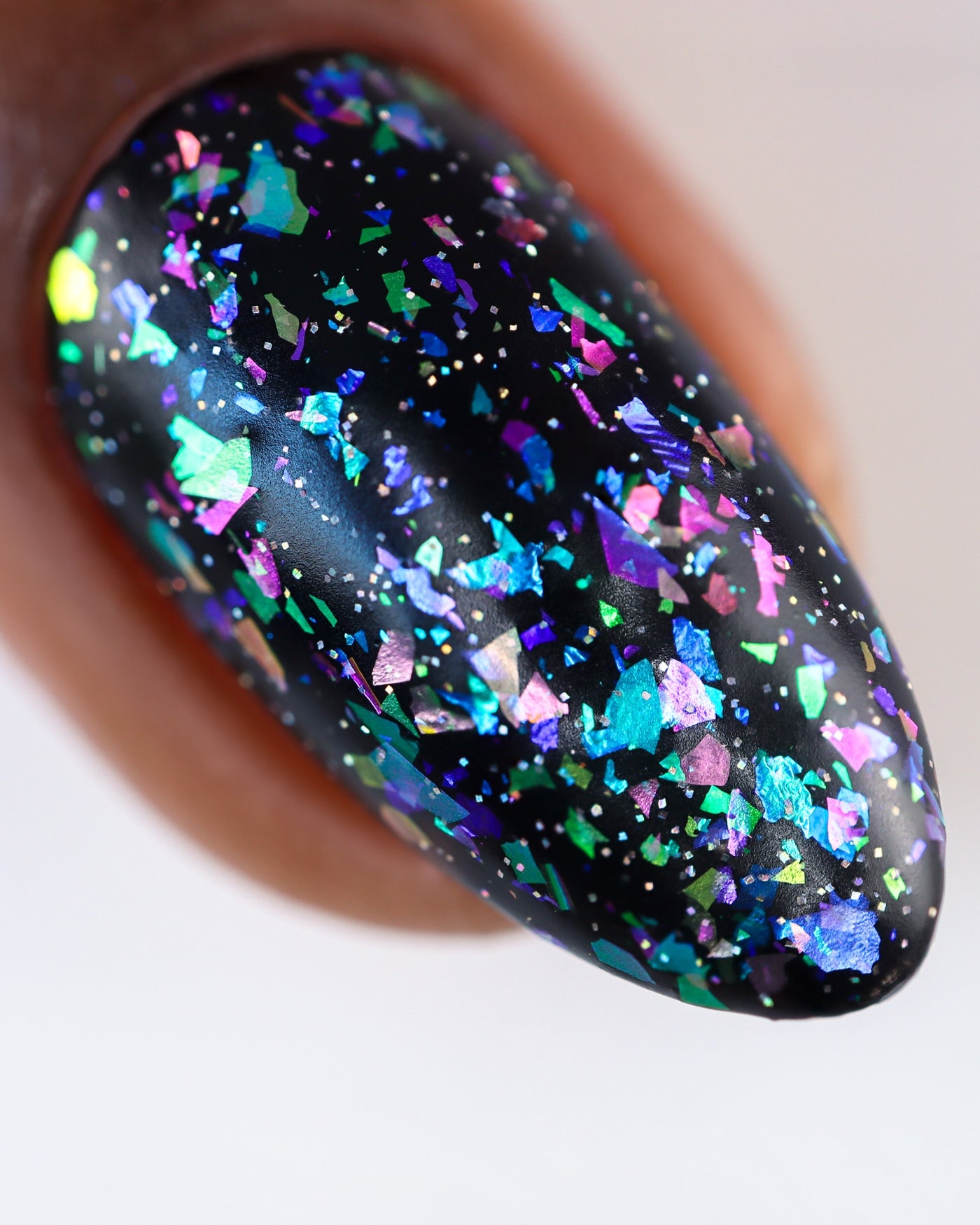 Glossy black nail with iridescent teal, purple, pink glitter from Sugar and Spice Topper