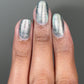 Atomica shimmering silver metallic nail polish with glittery reflective finish