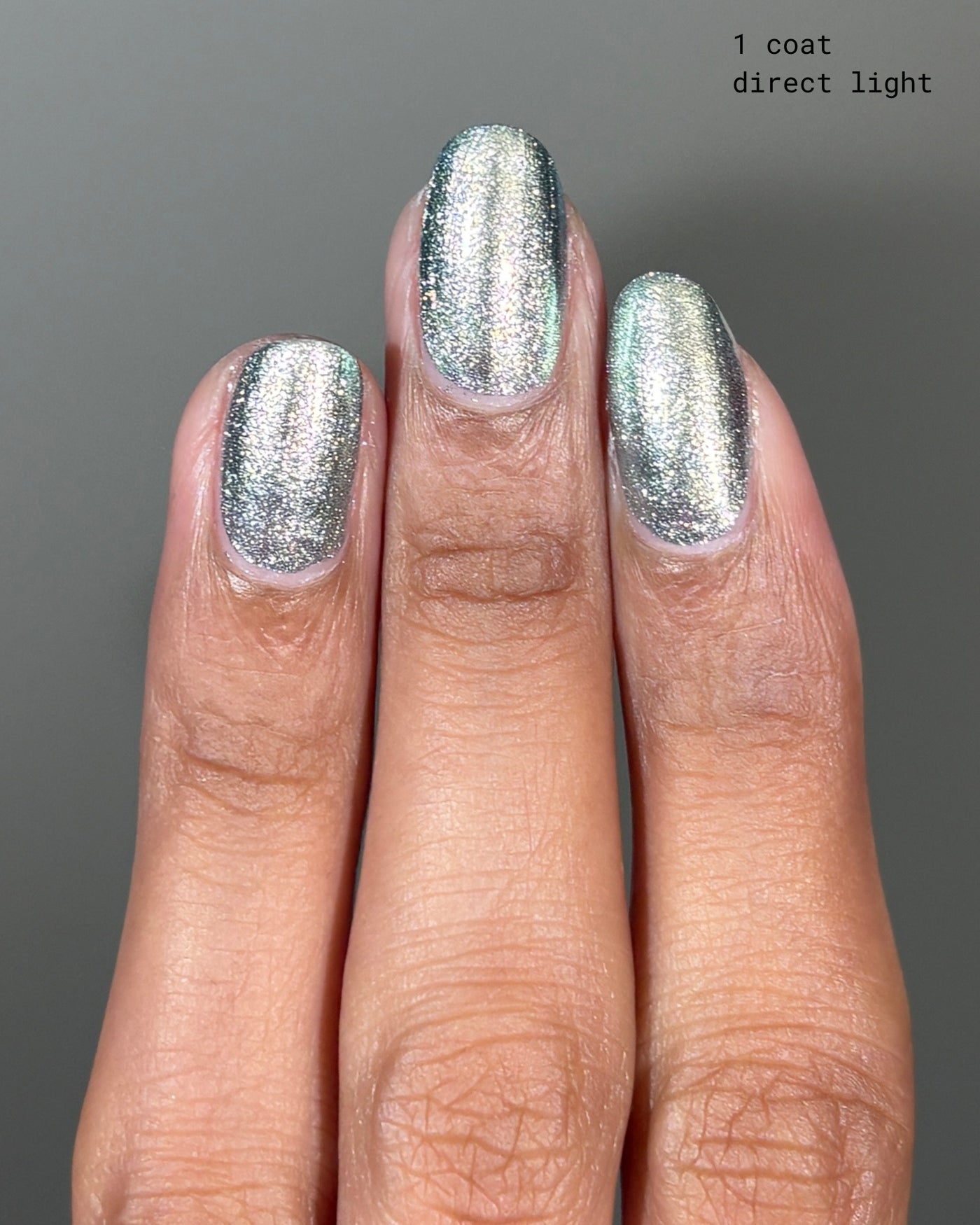 Atomica shimmering silver metallic nail polish with glittery reflective finish