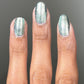 Shimmering silver-green Atomica nail polish in two coats