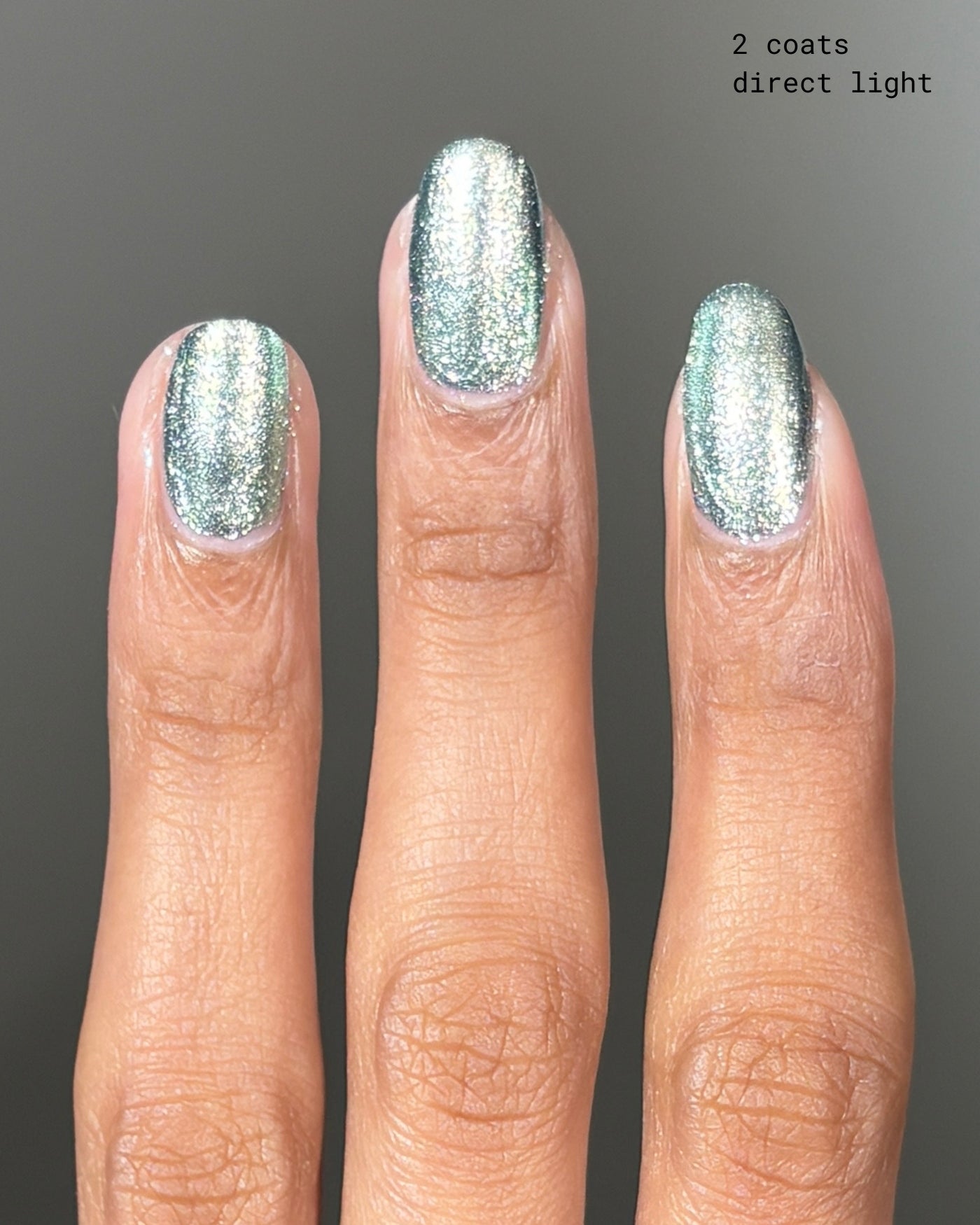 Shimmering silver-green Atomica nail polish in two coats