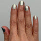 Shimmering Atomica silver nail polish in two coats under indirect light