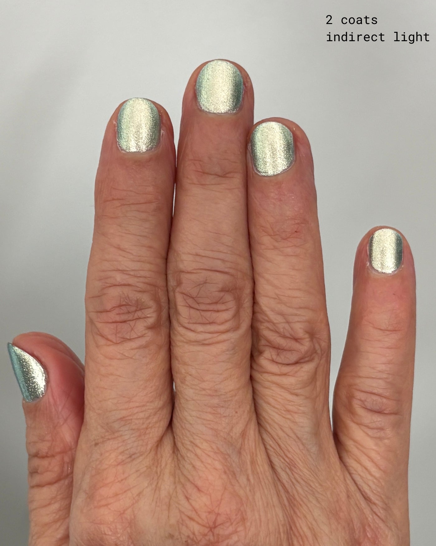 Shimmering Atomica silver nail polish in two coats