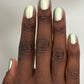 Shimmering metallic green Atomica nail polish in two coats