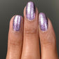 Shimmering Nightbreak lavender glitter nail polish, two coats under light