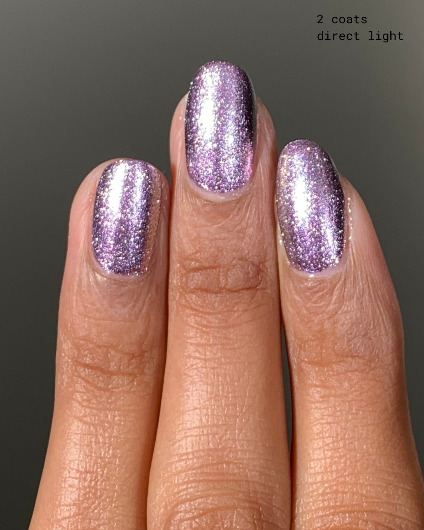 Shimmering Nightbreak lavender glitter nail polish, two coats under light