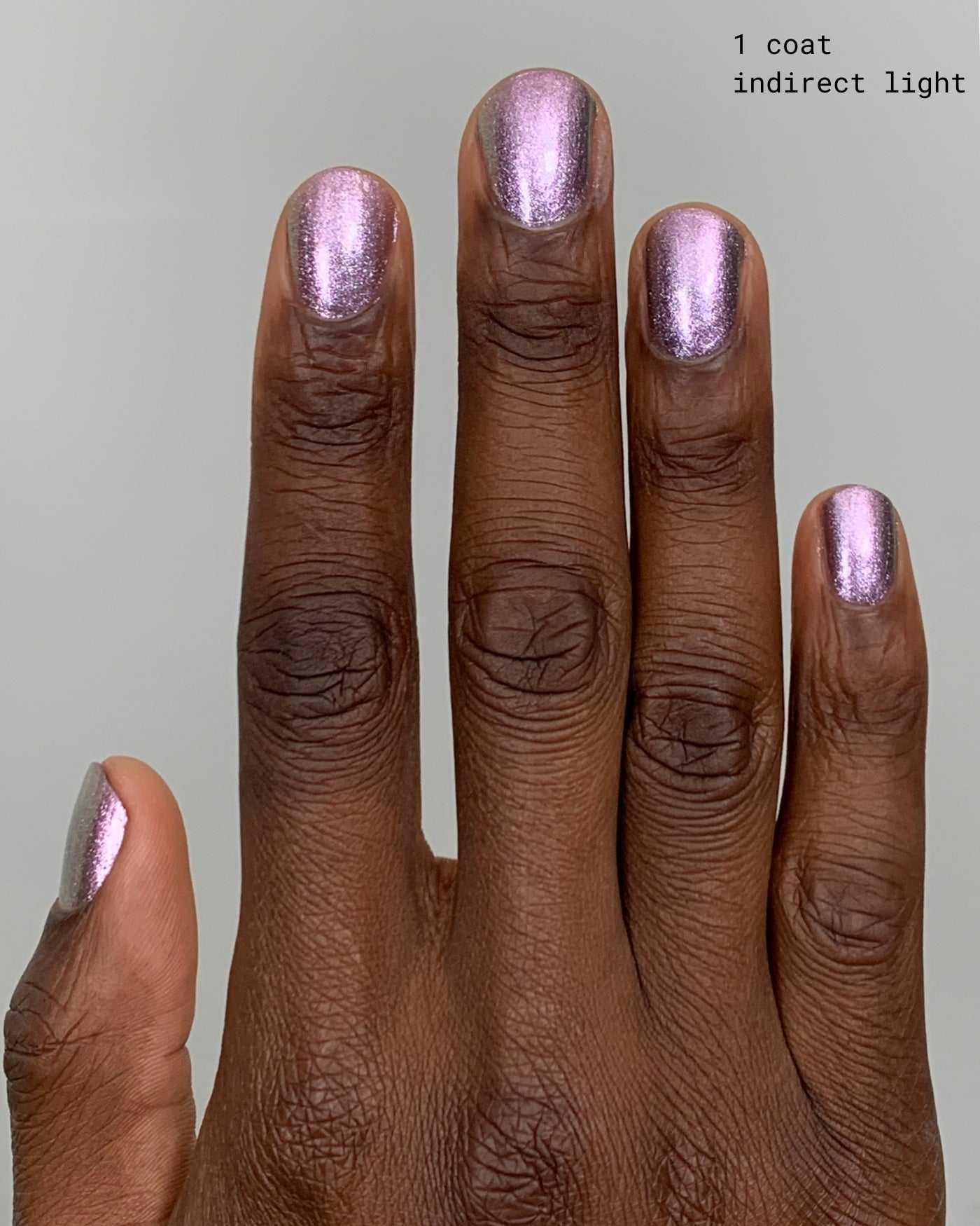 Shimmering lavender Nightbreak metallic nail polish in one coat under indirect light