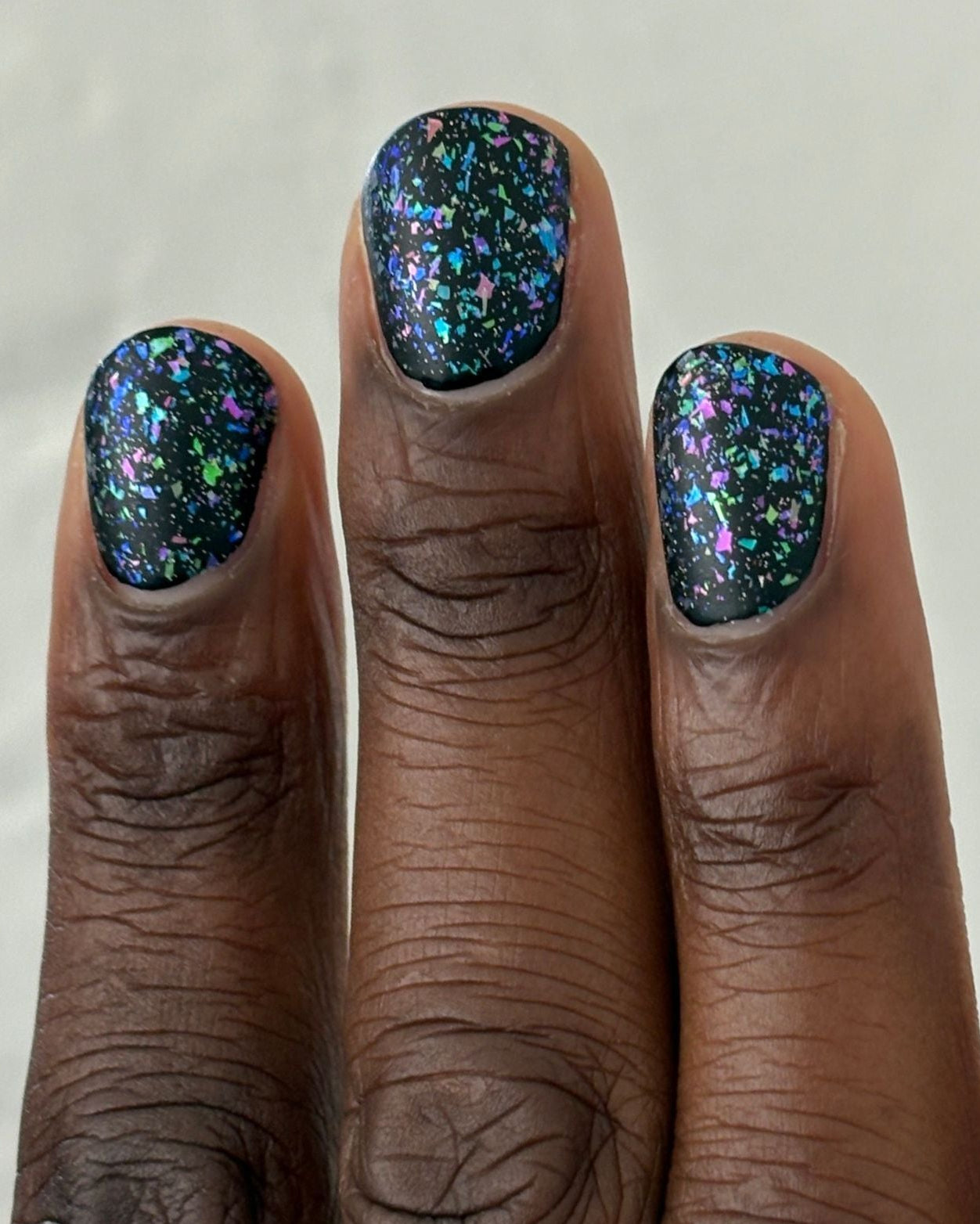 Sugar and Spice Topper: dark green nail polish with blue purple pink iridescent glitter