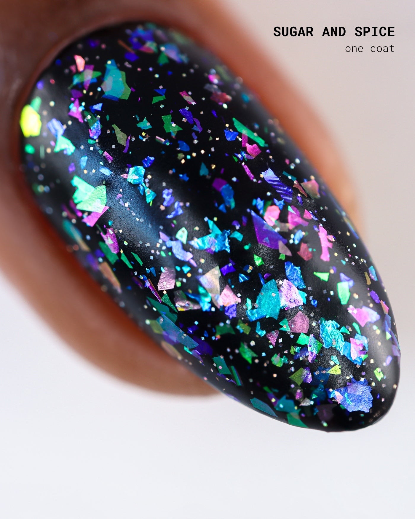 Glossy black nail polish with iridescent blue green purple pink glitter in Band Of Misfits II Set