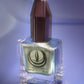Atomica shimmering green nail polish in square glass bottle with faceted cap