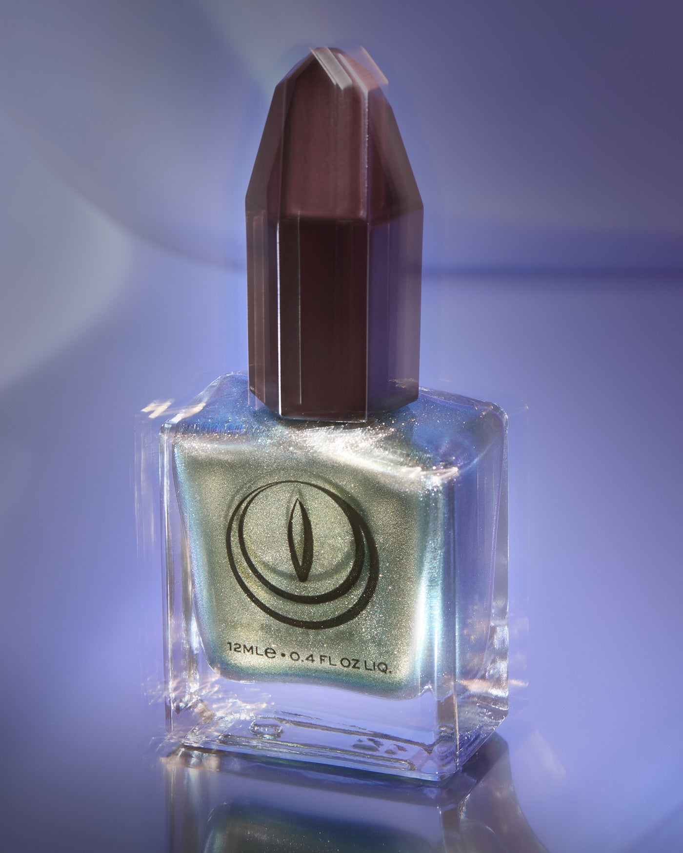 Atomica shimmering green nail polish in square glass bottle with faceted cap