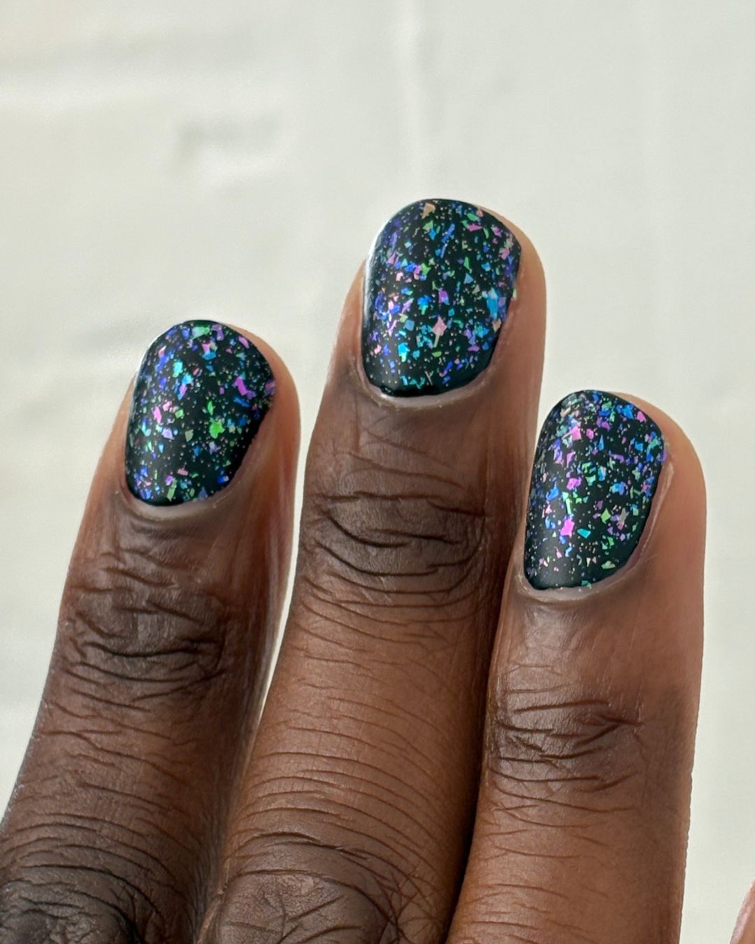 Sugar and Spice Topper: dark green nail polish with iridescent blue, purple, pink glitter